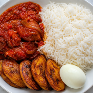Nigerian White Rice with Rich Tomato Stew, Fried Plantain & Boiled Egg